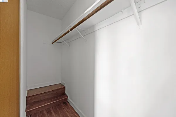 a view of a patio with a dining table and chairs with wooden floor and fence