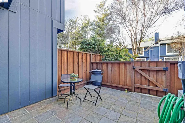 a backyard of a house with chairs and table and chairs