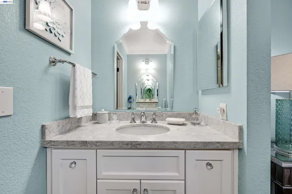 a white toilet sitting next to a bathroom sink