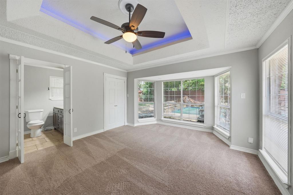 1108 Billie Ruth Lane Hurst, TX 76053 - Photo 4 of 27 Spacious room featuring a tray ceiling with recessed lighting, a ceiling fan, and carpeted flooring