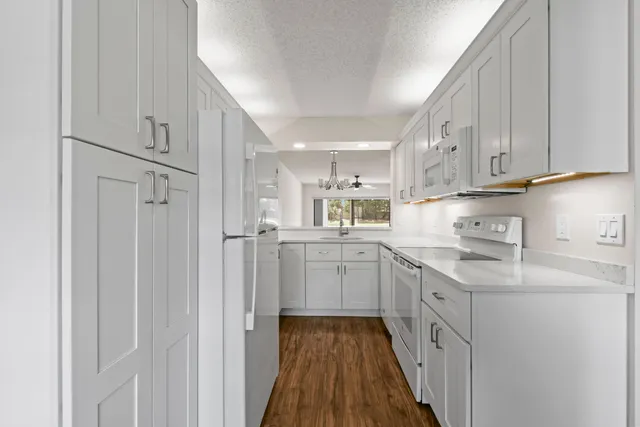a bathroom with a double vanity sink toilet and shower