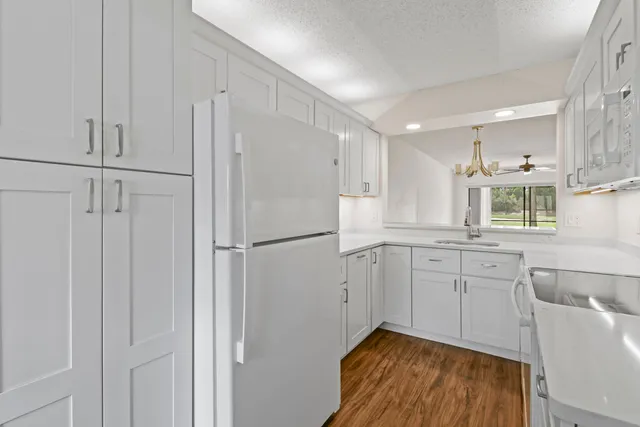 an empty room with fan and windows