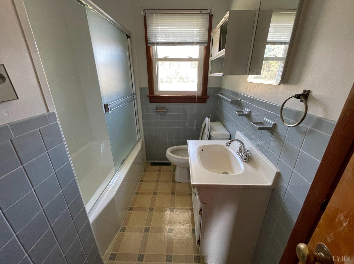 363 Lynbrook Road Rustburg, VA 24588 - Photo 12 of 19 a bathroom with a sink a toilet a mirror and window