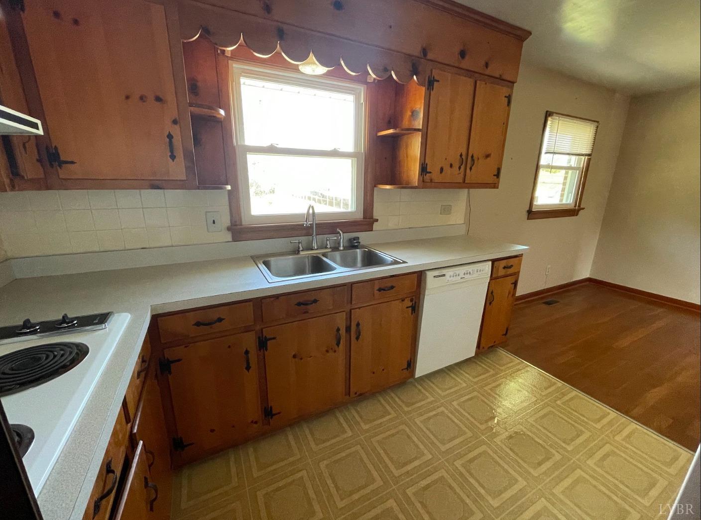 363 Lynbrook Road Rustburg, VA 24588 - Photo 6 of 19 a kitchen with a sink a stove cabinets and a window