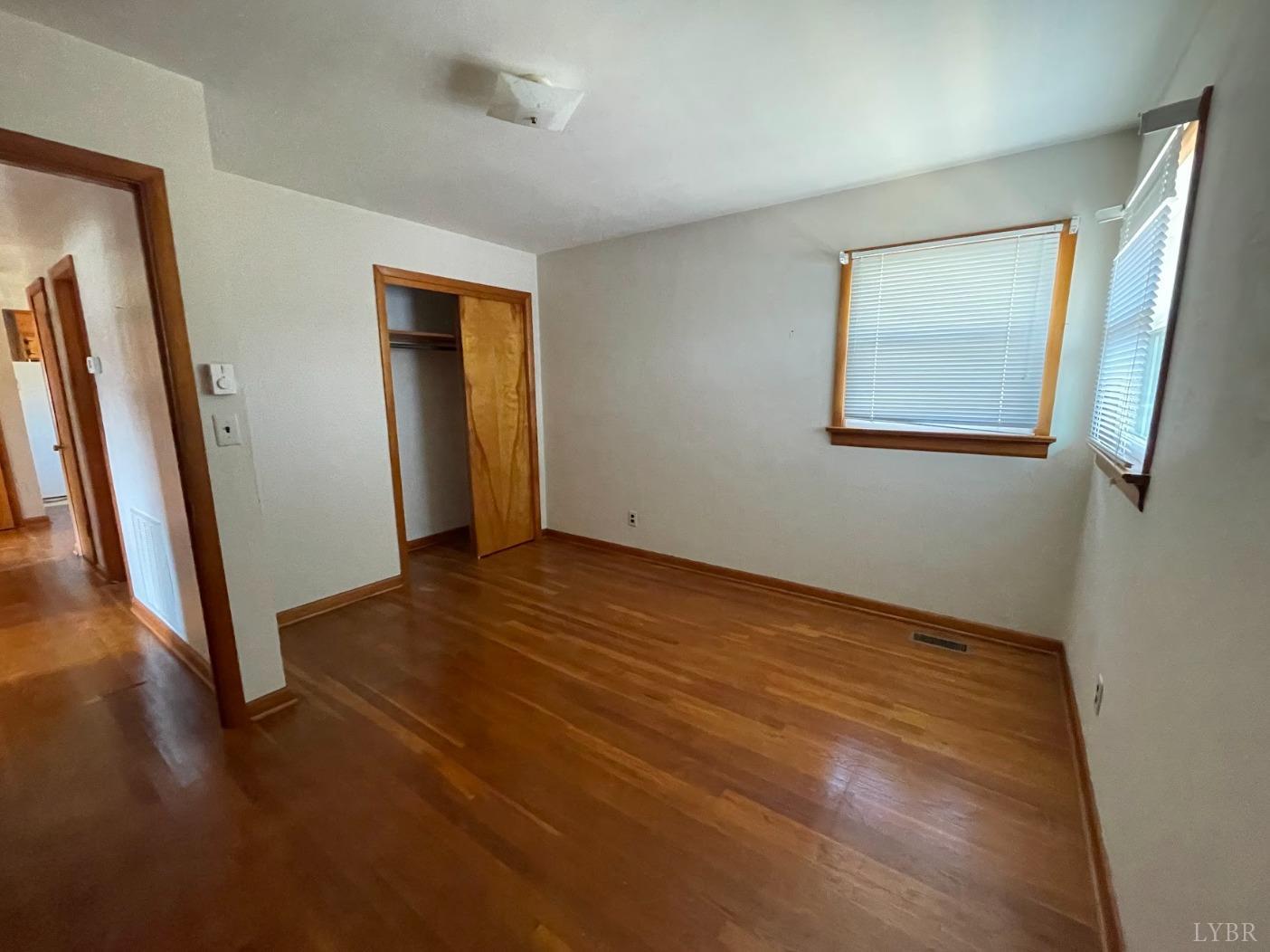 363 Lynbrook Road Rustburg, VA 24588 - Photo 10 of 19 a view of an empty room with wooden floor and a window