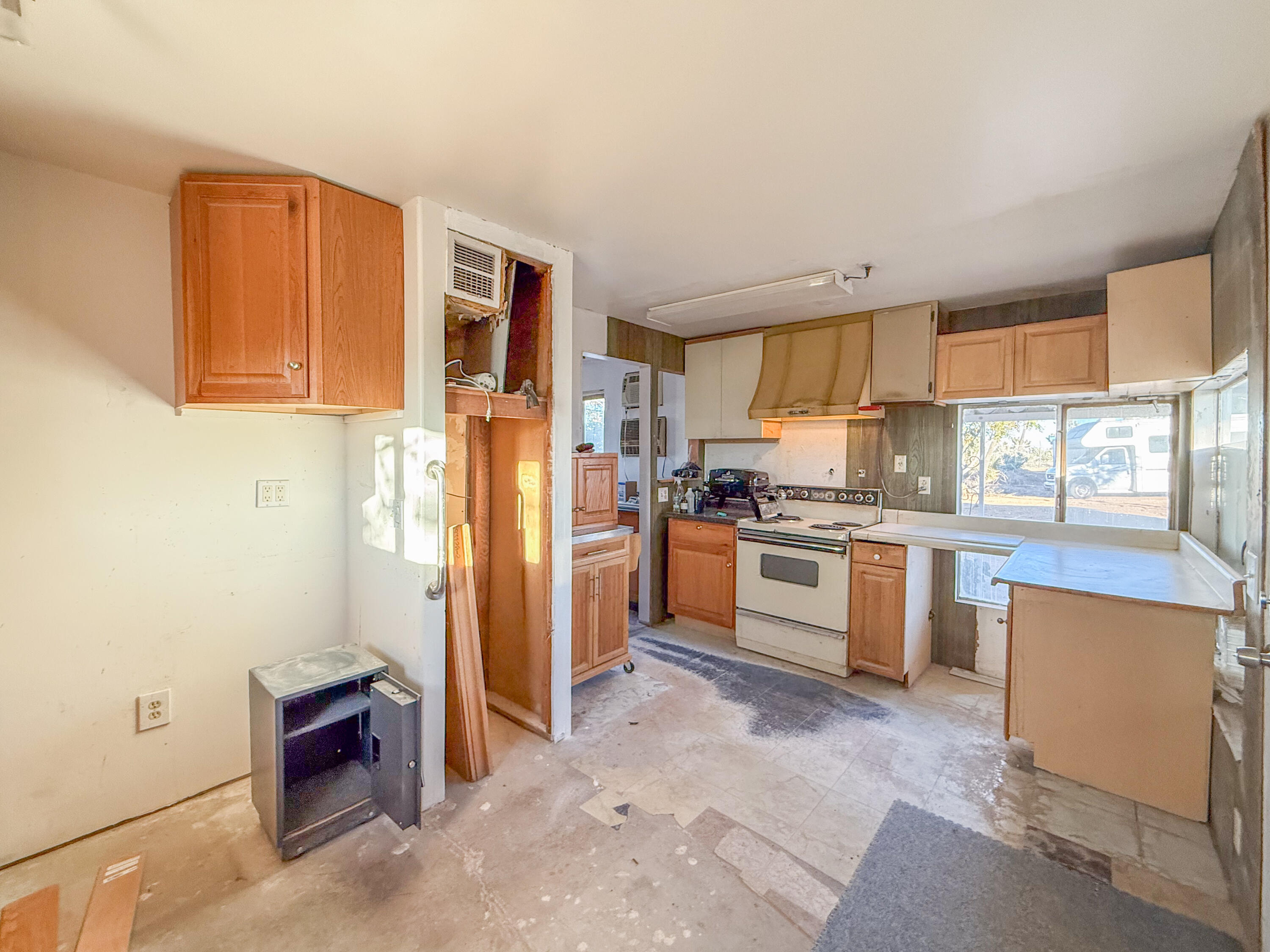 56606 Skyline Ranch Road Yucca Valley, CA 92284 - Photo 6 of 19 a kitchen with granite countertop a refrigerator stove top oven and sink