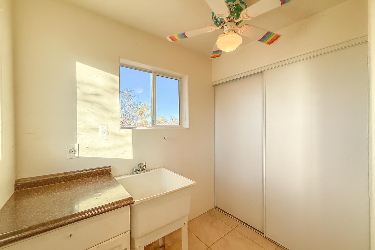 56606 Skyline Ranch Road Yucca Valley, CA 92284 - Photo 7 of 19 a room with a window and ceiling fan