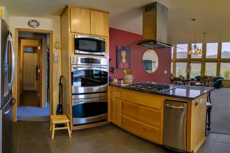 8707 Yank Gulch Road Talent, OR 97540 - Photo 9 of 19 a kitchen with stainless steel appliances granite countertop a stove and a microwave
