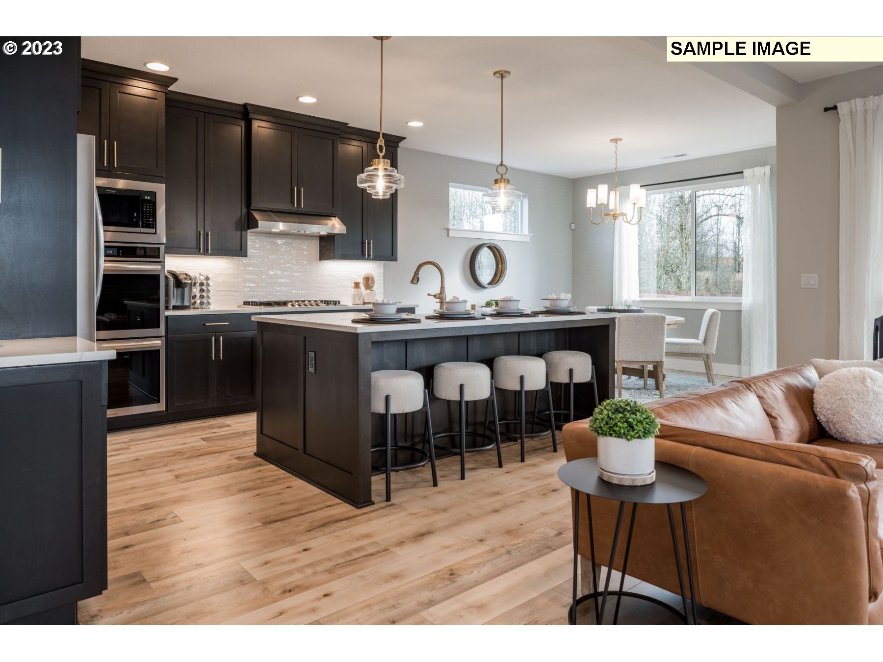 1003 South 46th Place Ridgefield, WA 98642 - Photo 6 of 21 a kitchen with stainless steel appliances kitchen island granite countertop a sink and cabinets
