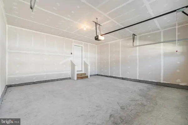 a view of an empty room with a white walls