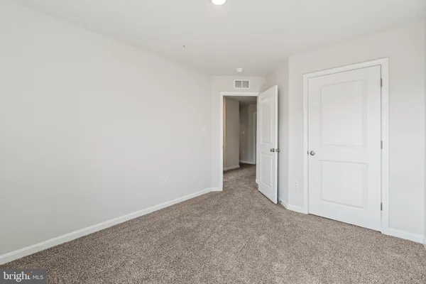 a view of an empty room and closet area