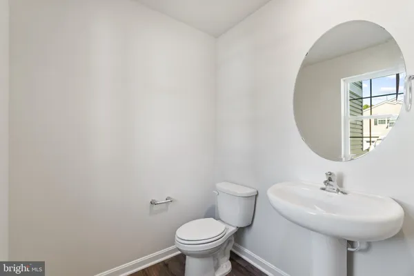 a bathroom with a sink a mirror and a toilet