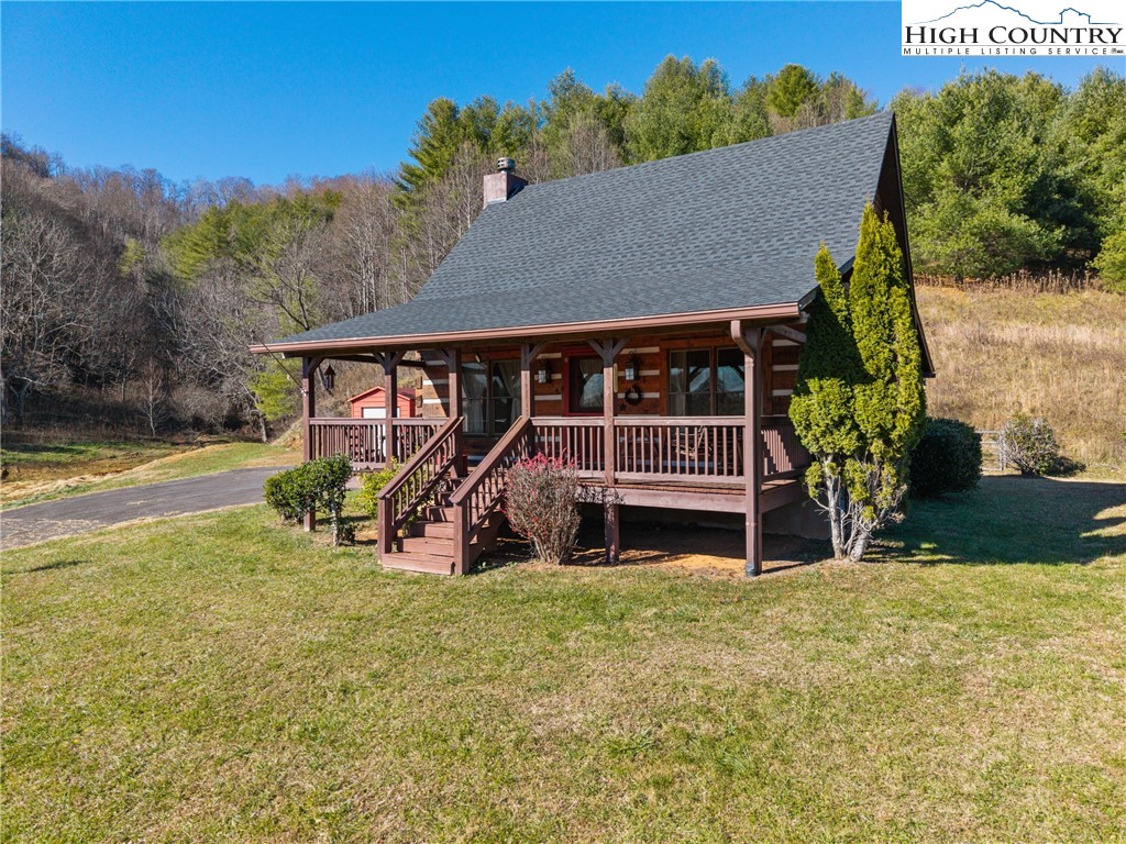 a view of a house with backyard porch and sitting area