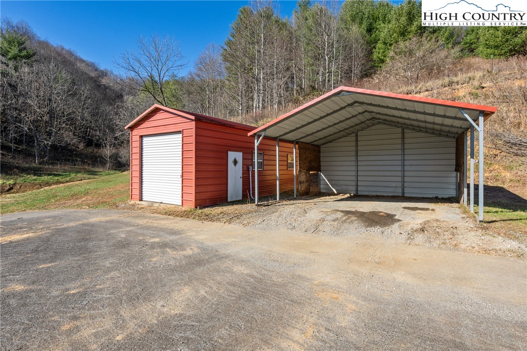 183 Laurel Branch Road Vilas, NC 28692 - Photo 26 of 39 a front view of a house with a yard and garage