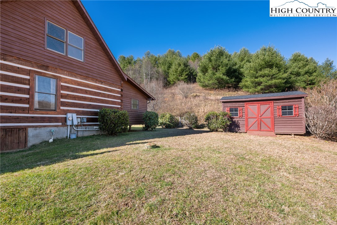 183 Laurel Branch Road Vilas, NC 28692 - Photo 29 of 39 a front view of a house with a yard and garage
