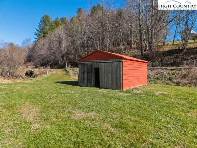 a view of a backyard with swimming pool