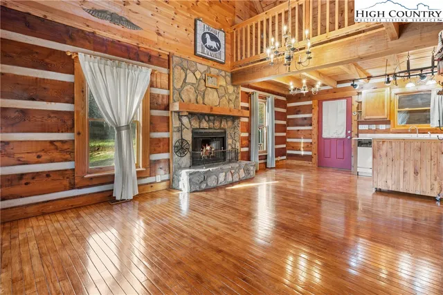 a view of a room with wooden floor and fireplace