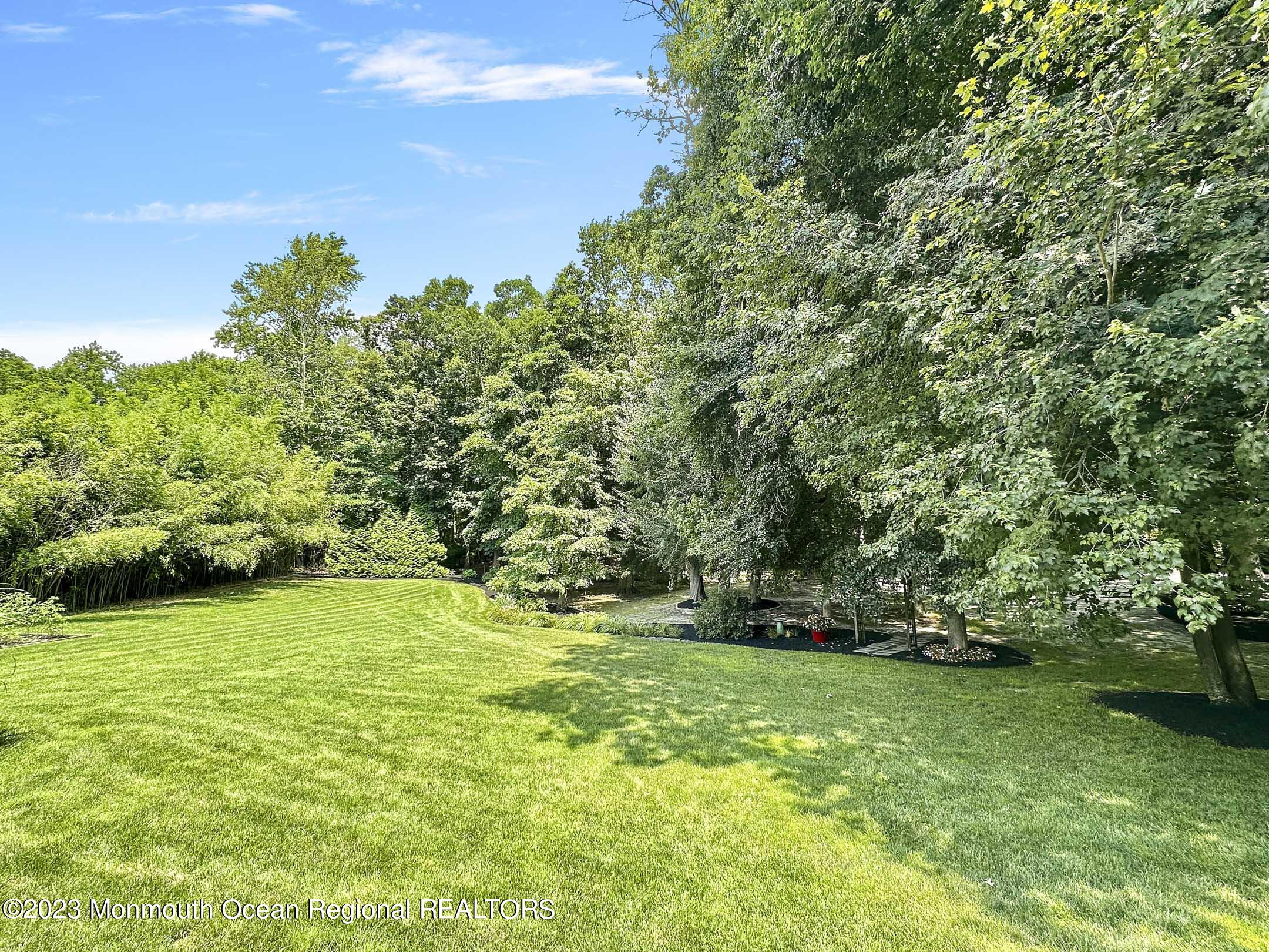 1228 West Farms Road Howell, NJ 07731 - Photo 54 of 59 a view of a field with trees in the background
