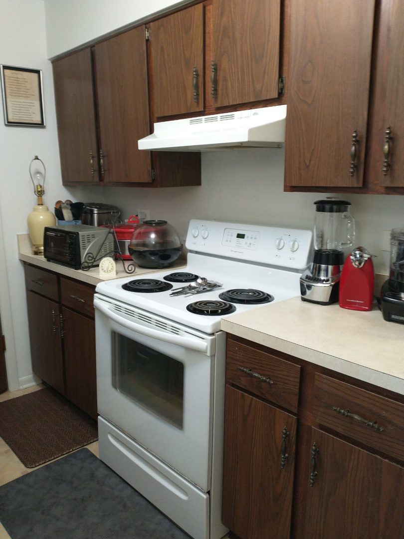 613 West Central Road, Unit A8 Mount Prospect, IL 60056 - Photo 14 of 23 a kitchen with stainless steel appliances a stove a microwave a sink and cabinets