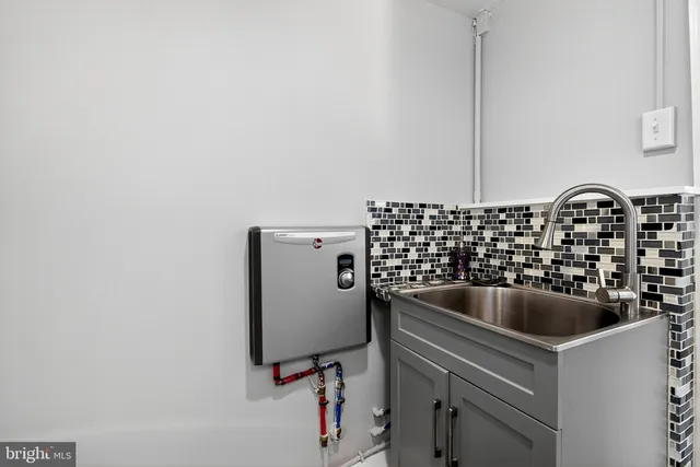 a kitchen with a refrigerator and a sink