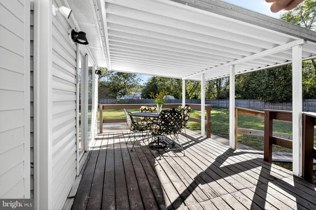a view of a balcony with chairs and wooden floor