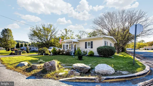 a view of a house with swimming pool and a yard
