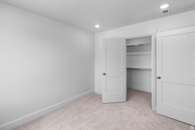 1237 West 500 South, Unit 230 Logan, UT 84321 - Photo 39 of 42 Neutral-toned carpet flooring, recessed ceiling lights, and a closet featuring a white flat-panel door with metal hardware and built-in shelving