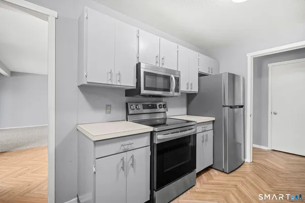 a kitchen with a stove sink and refrigerator