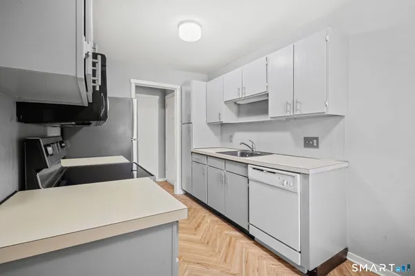 a kitchen with a cabinets and wooden floor