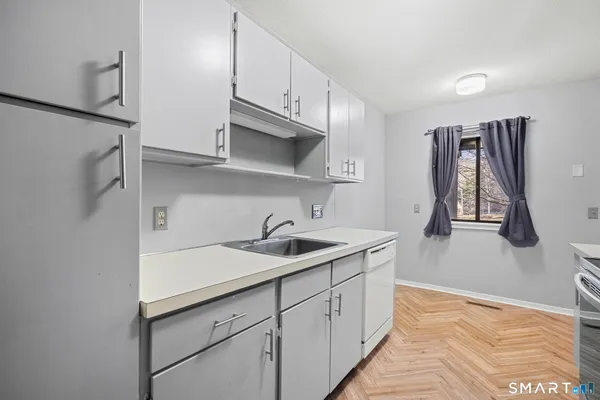 a kitchen with a sink and cabinets