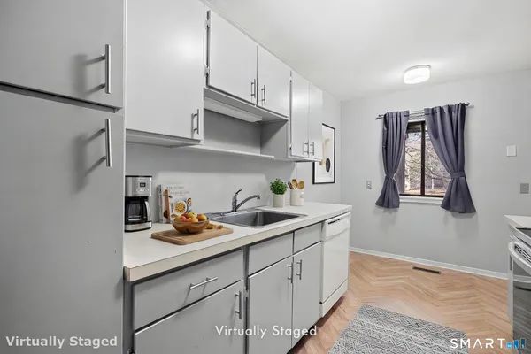 a kitchen with stainless steel appliances granite countertop a sink stove and cabinets