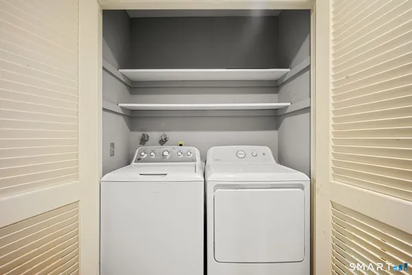a view of storage and utility room with washer and dryer