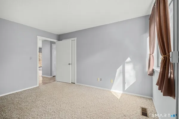 a view of an empty room with a window