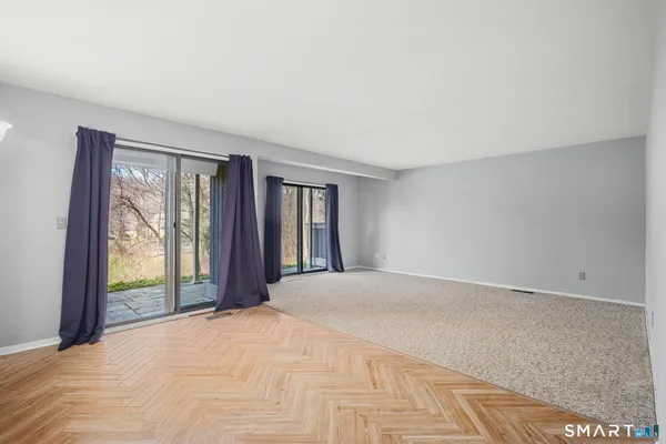 a view of an empty room with large windows