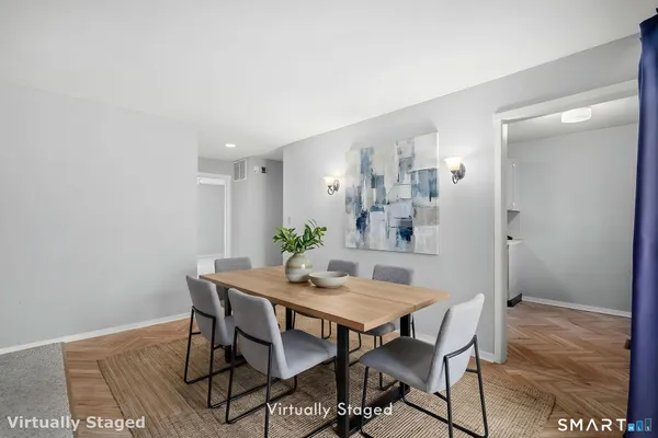 a view of a dining room with furniture and wooden floor