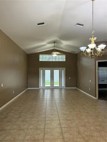 an empty room with closet and fan