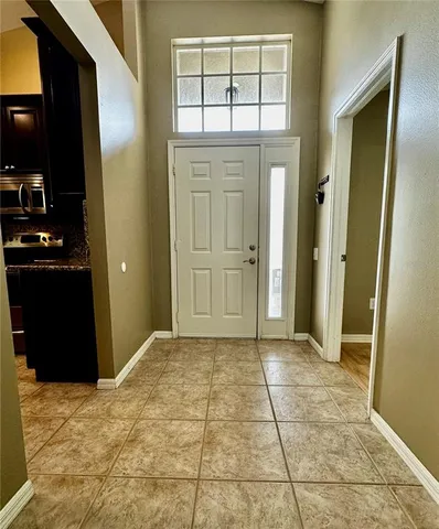 a kitchen with granite countertop wooden cabinets and stainless steel appliances