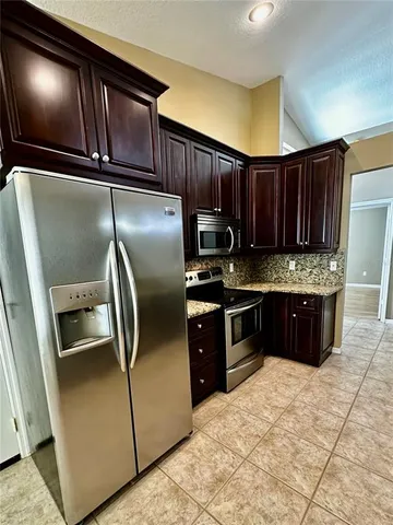 a view of a kitchen with a sink and chandelier