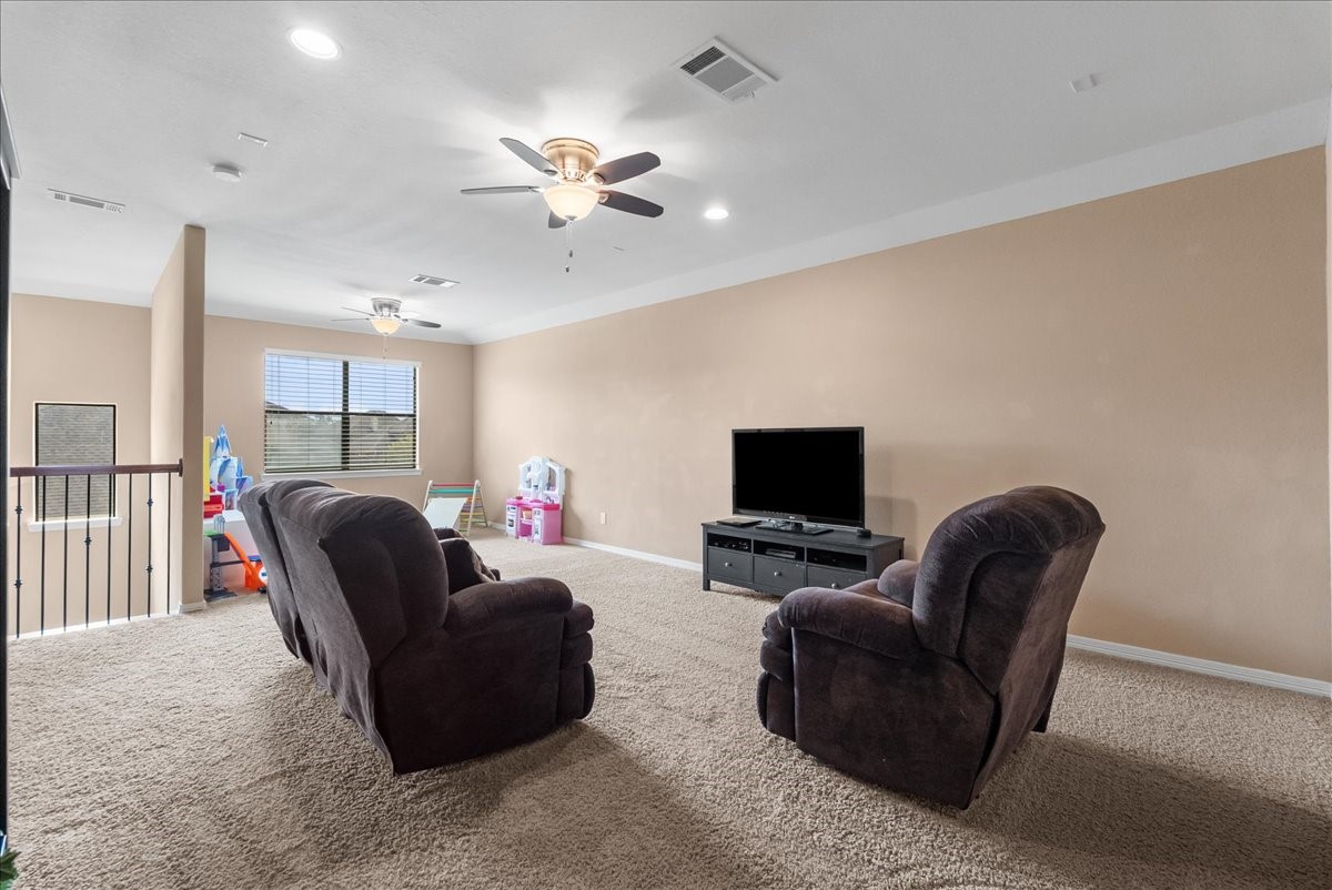 606 West Fork Webster, TX 77598 - Photo 37 of 46 Spacious, light-filled gameroom perfect for family movie nights or a hobby space, complete with a convenient half-bath for guests on the upper level of this Edgewater home.