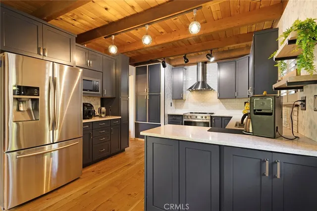 a kitchen with stainless steel appliances a refrigerator and a stove