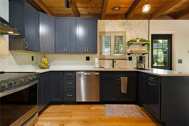 a kitchen with stainless steel appliances granite countertop a sink stove and cabinets