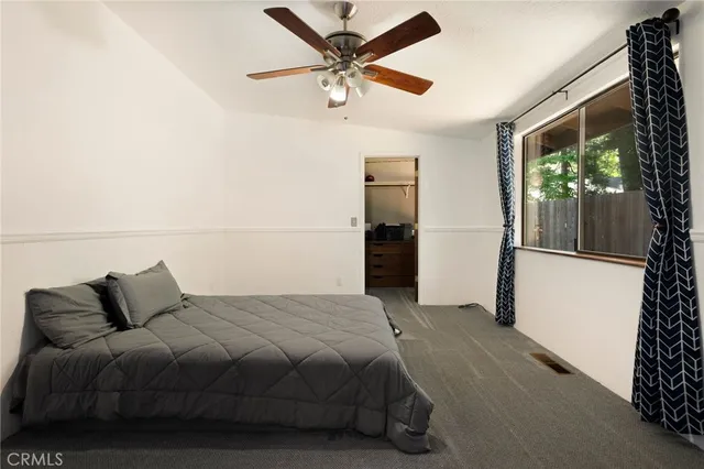 a bedroom with a bed and a large window