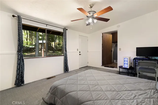 a bedroom with a large bed and a tv