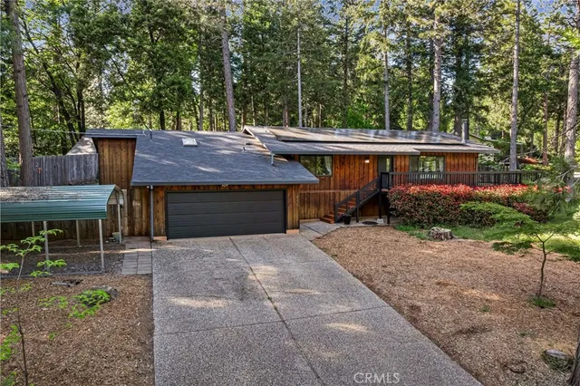 a view of house with backyard and seating space