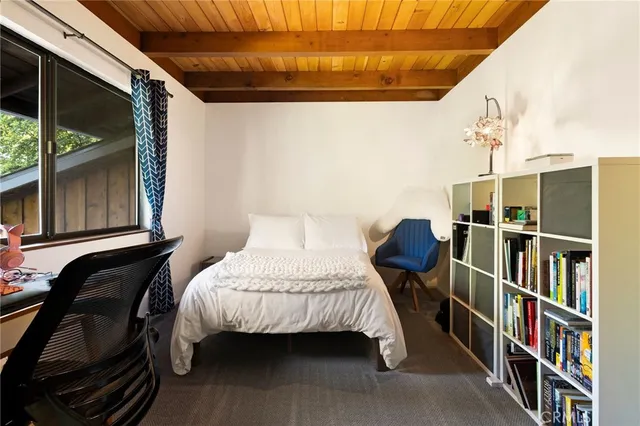 a bedroom with bed and a book shelf