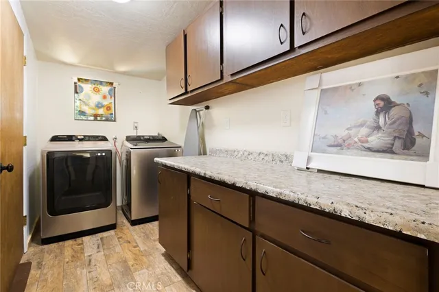 a view of a kitchen with stainless steel appliances granite countertop cabinets and wooden floor
