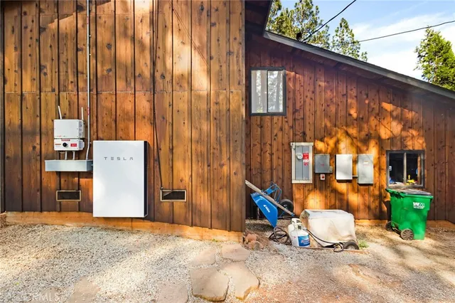 a backyard of a house with barbeque oven and outdoor seating
