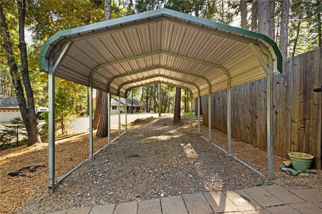 a view of a patio with table and chairs with wooden floor and fence