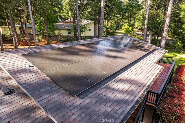 a view of a backyard with a wooden deck and a garden