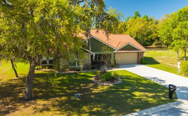 a view of a house with a yard and sitting area